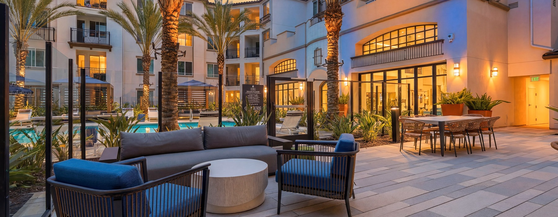 a patio with chairs and tables and trees