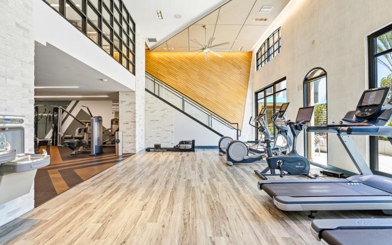a room with exercise equipment and a staircase
